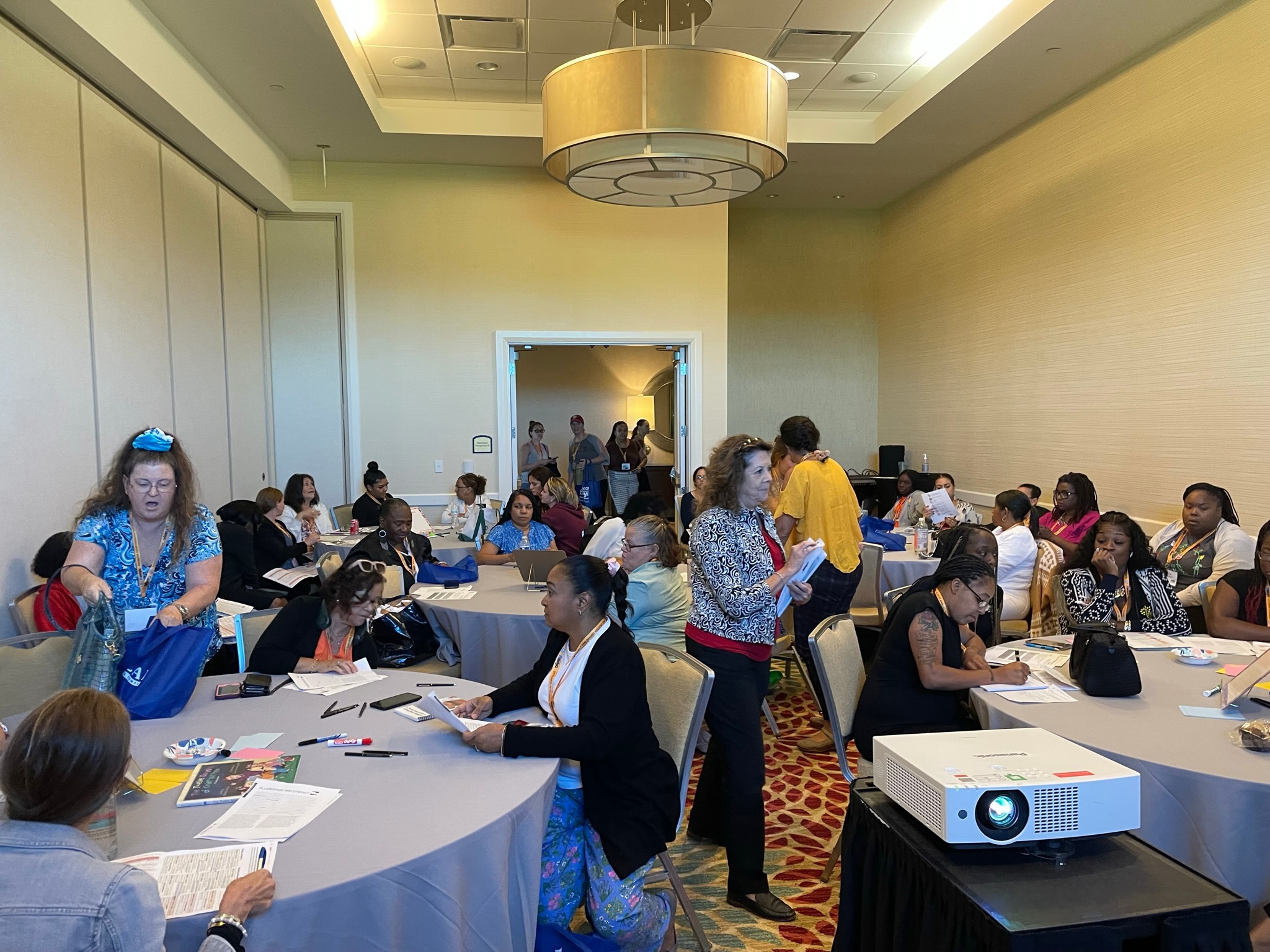 A conference room with participants engaged in a coaching session